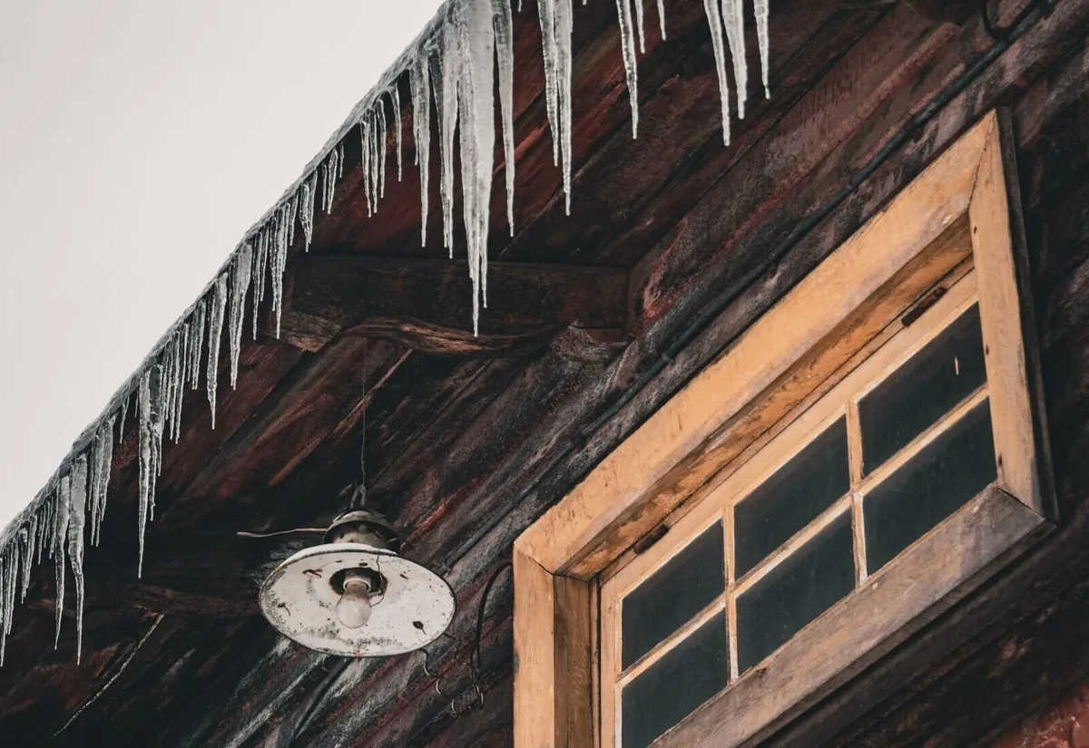 Ice dam and heavy icicles along the eave of a Grand Rapids home, the trouble spot where roof heat cables are typically installed
