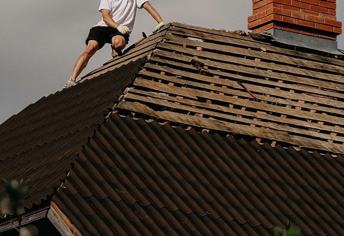 Roofing contractor installing new asphalt shingles on a Grand Rapids, Michigan home during a mild-weather booking window