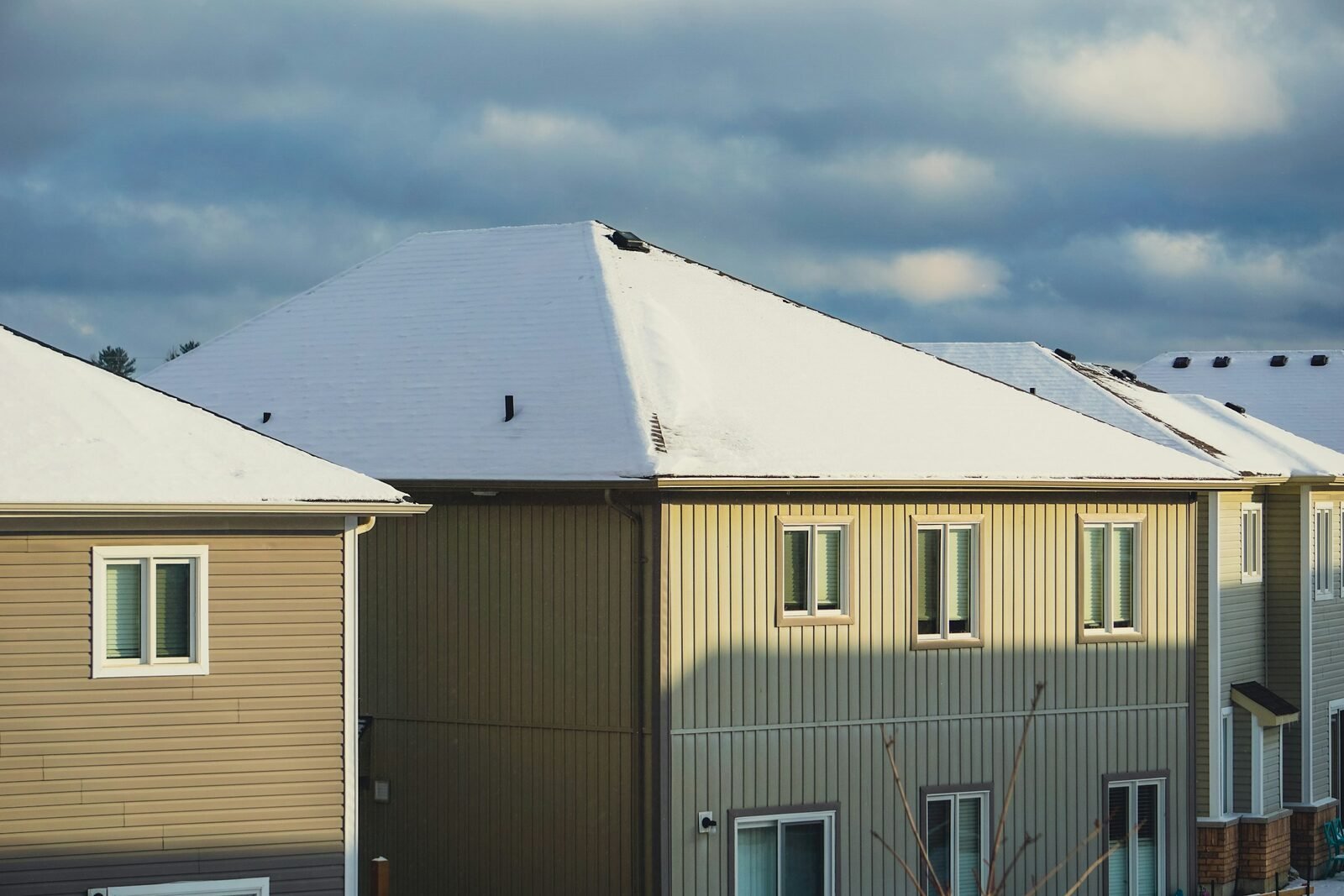 Newer two-story Caledonia, MI home with a snow-covered roof and vinyl siding, representative of the township&rsquo;s fast-growing subdivisions